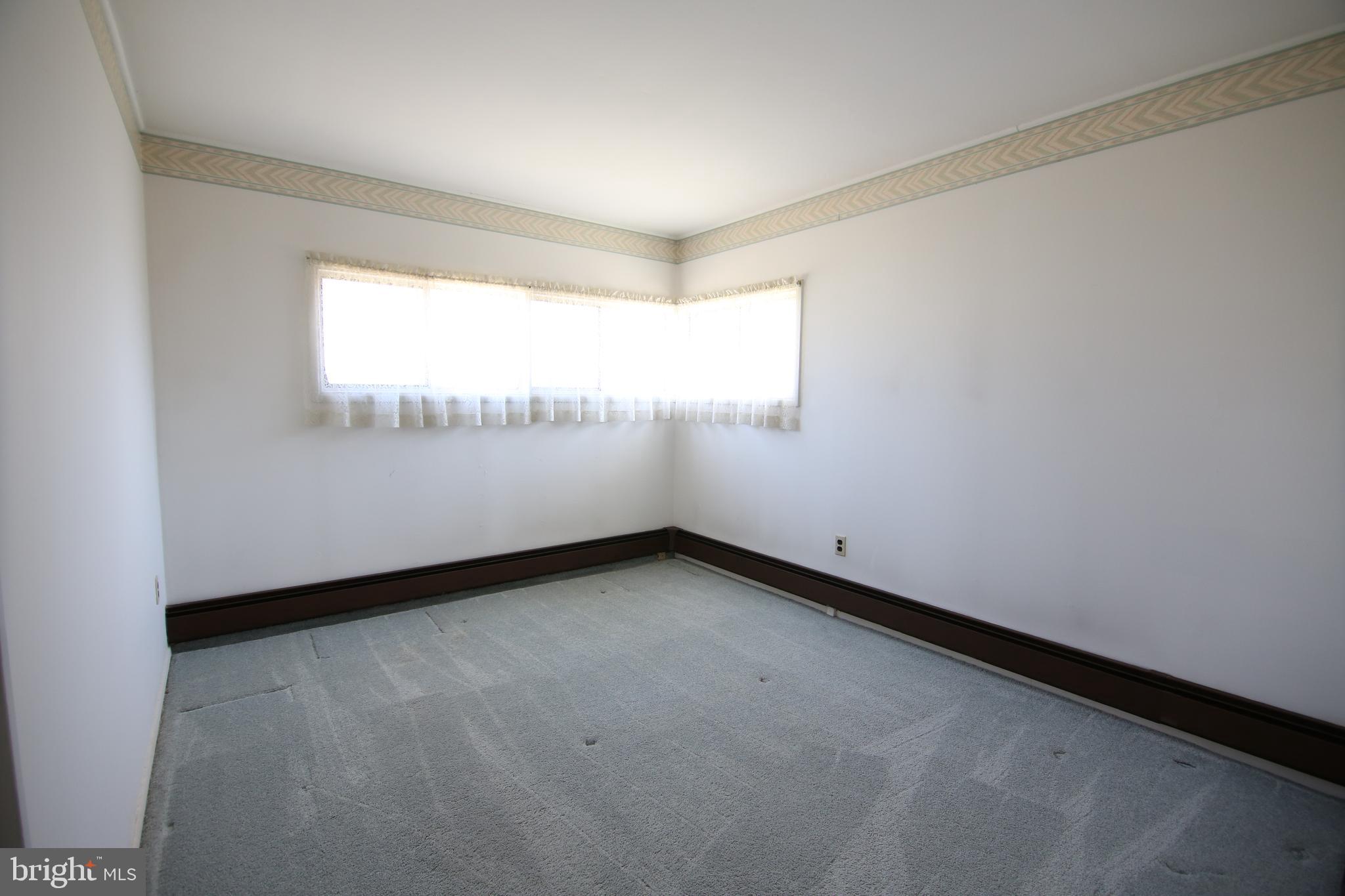 126 Gable Hill Road Levittown, PA 19057 - Photo 8 of 16 a view of an empty room and window