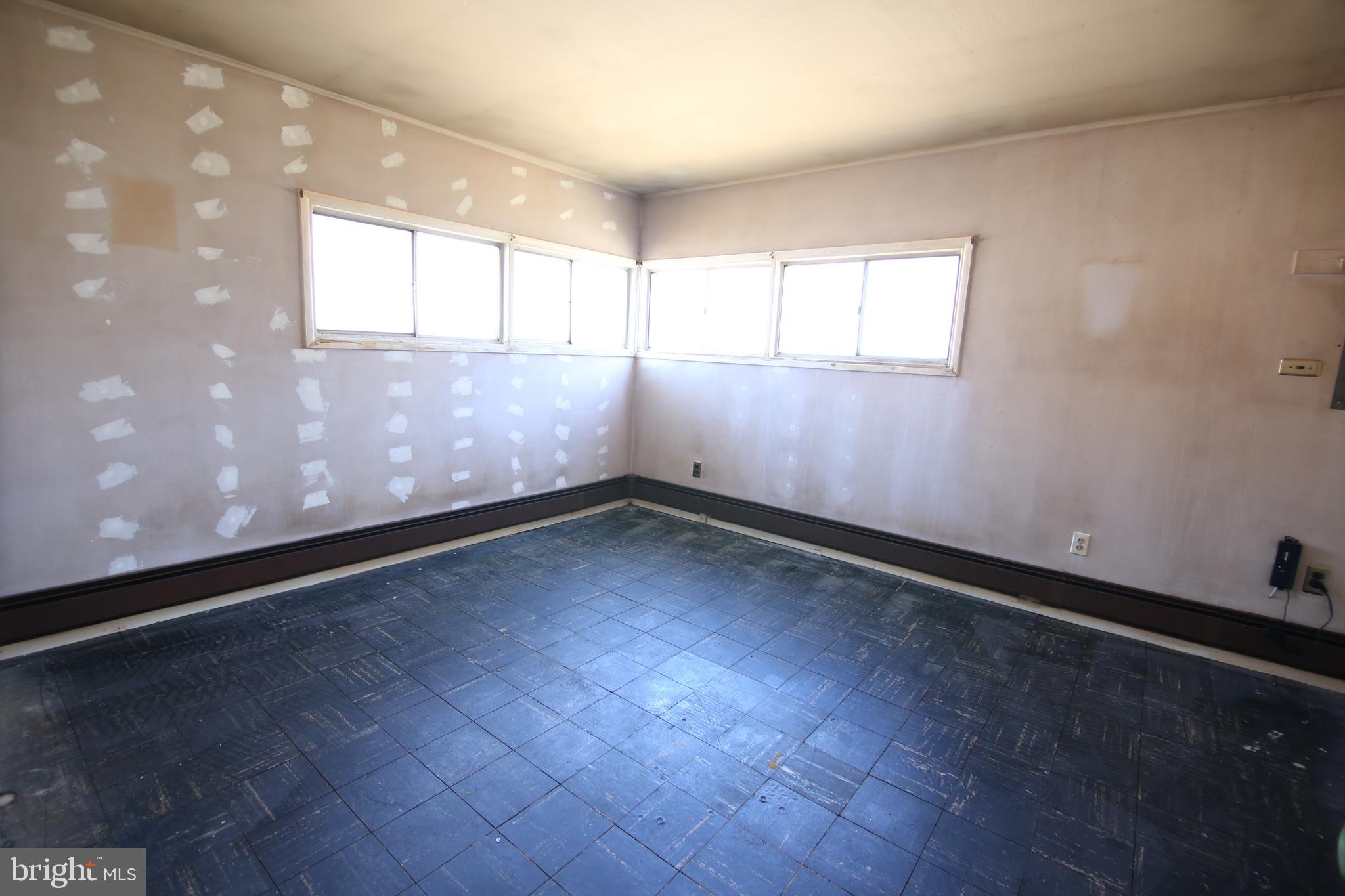 126 Gable Hill Road Levittown, PA 19057 - Photo 9 of 16 an empty room with wooden floor and windows