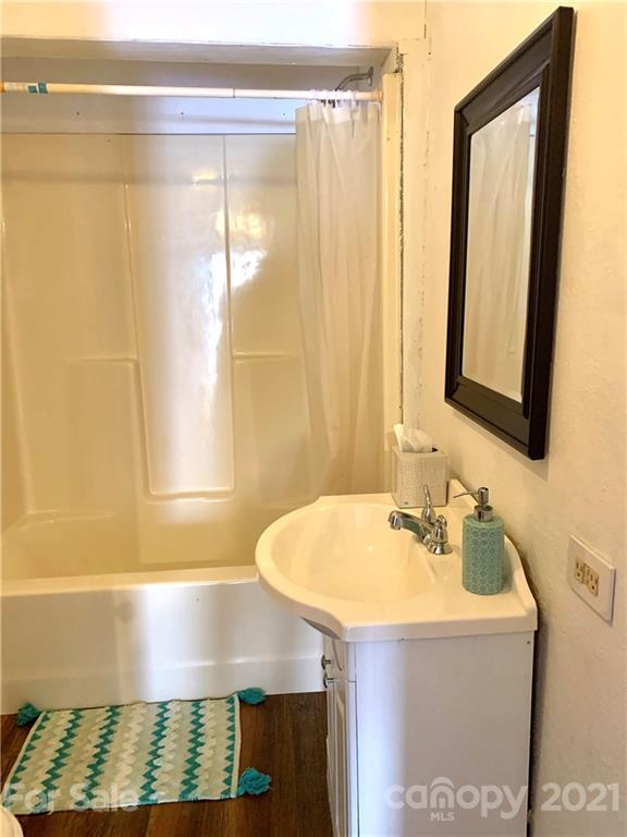 559 Thompson Cove Road Clyde, NC 28721 - Photo 11 of 36 a bathroom with a sink and a mirror
