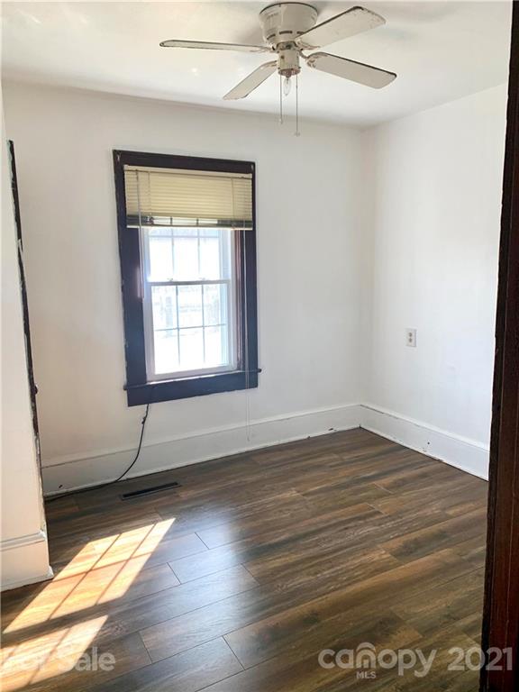 559 Thompson Cove Road Clyde, NC 28721 - Photo 15 of 36 an empty room with wooden floor and windows