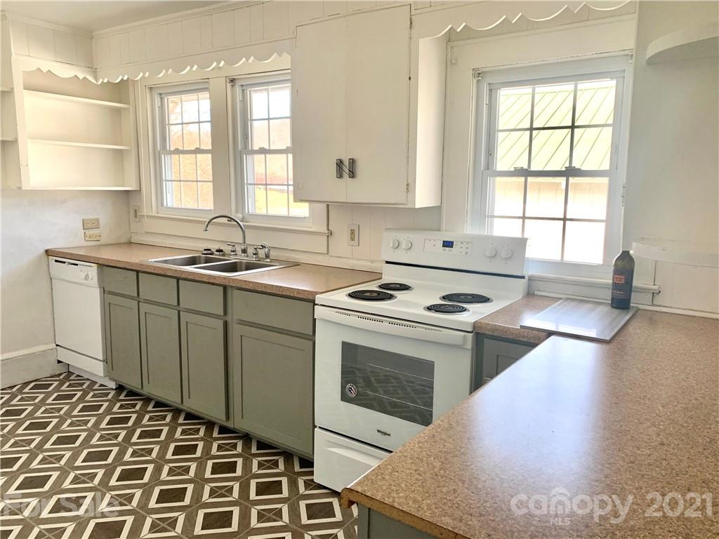 559 Thompson Cove Road Clyde, NC 28721 - Photo 18 of 36 a kitchen with a sink stove and cabinets