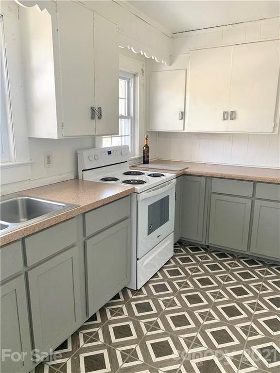 559 Thompson Cove Road Clyde, NC 28721 - Photo 19 of 36 a kitchen with a stove a sink and a window