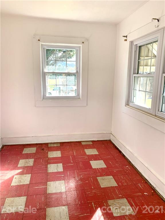 559 Thompson Cove Road Clyde, NC 28721 - Photo 28 of 36 an empty room with a rug