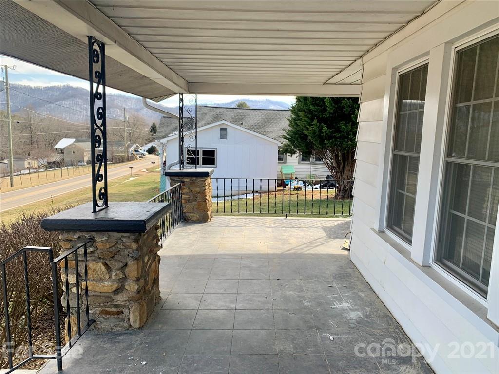 559 Thompson Cove Road Clyde, NC 28721 - Photo 4 of 36 a swimming pool with outdoor seating and yard