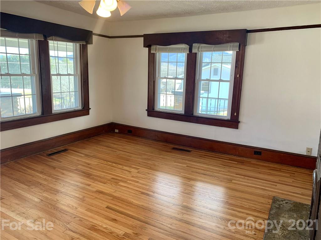 559 Thompson Cove Road Clyde, NC 28721 - Photo 6 of 36 a view of an empty room with wooden floor and a window