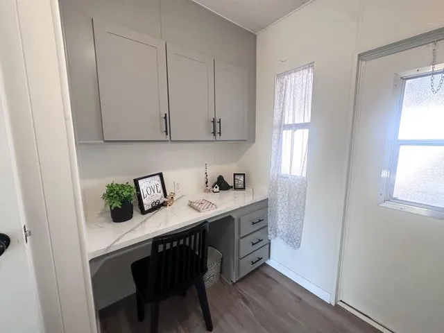 a view of kitchen with wooden floor and electronic appliances