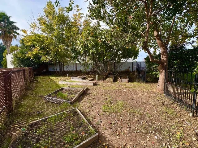 a view of a house with a tree beside a yard