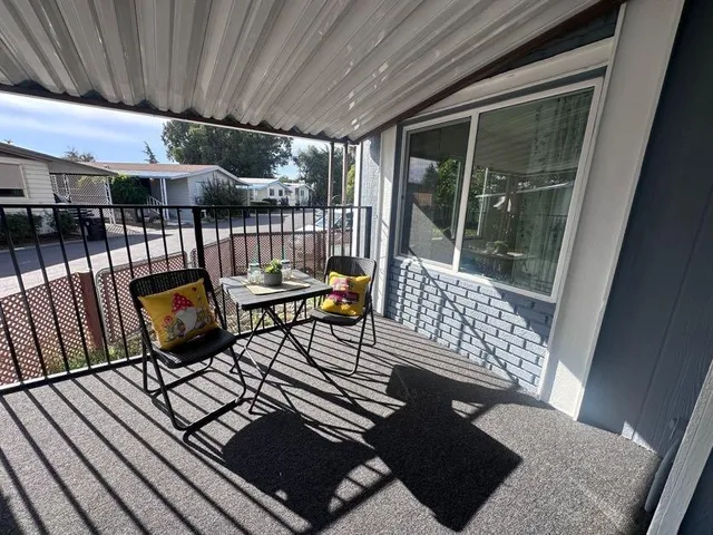 a view of a chairs and table in the balcony