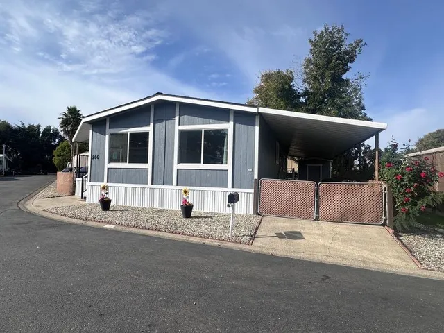 a view of street along with house and car parked