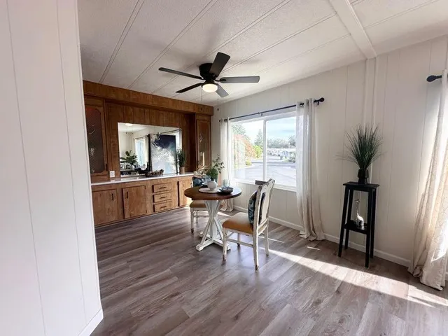 a view of a dining room with furniture window and wooden floor