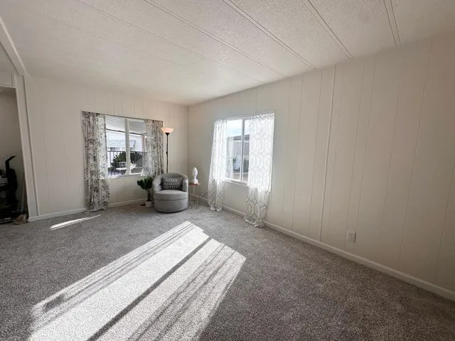 a spacious bedroom with a bed and a window