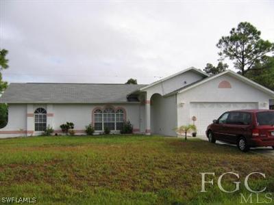 8385 Bamboo Road Fort Myers, FL 33967 - Photo 1 of 1 a car parked in front of a house with a yard