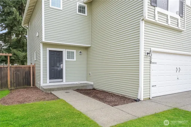 a view of a house with a yard and garage