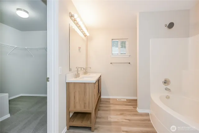 a bathroom with a sink a mirror and a bathtub