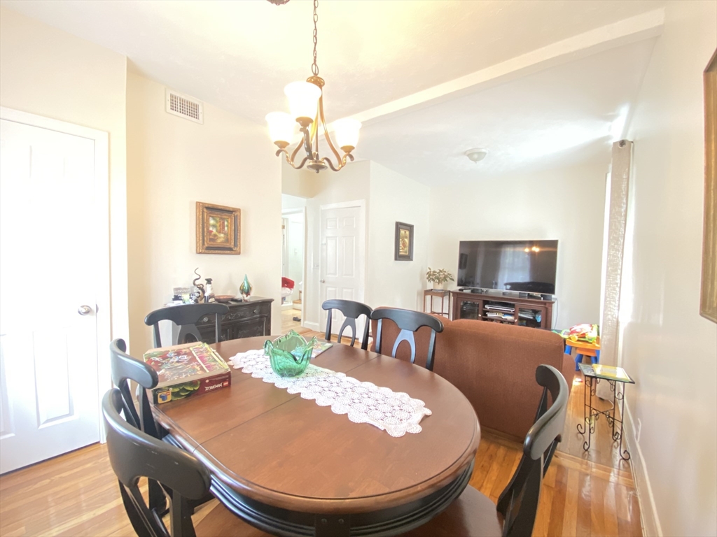 1 Minton Street, Unit 2 Boston, MA 02130 - Photo 6 of 12 a living room with furniture a dining table and a chandelier