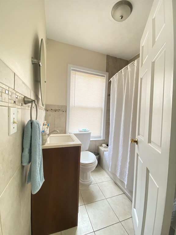 1 Minton Street, Unit 2 Boston, MA 02130 - Photo 7 of 12 a bathroom with a granite countertop sink toilet and shower