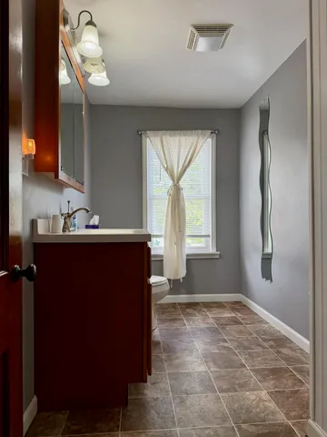 a room with a sink cabinets and wooden floor