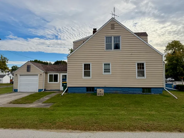 a front view of a house with a yard table and chairs
