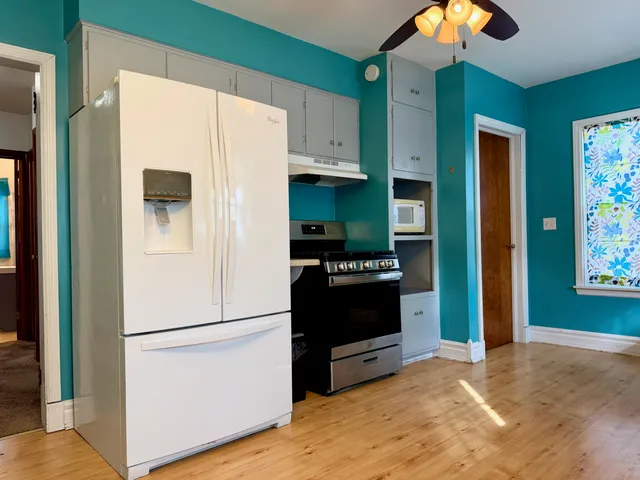 a kitchen with stainless steel appliances a refrigerator and a stove