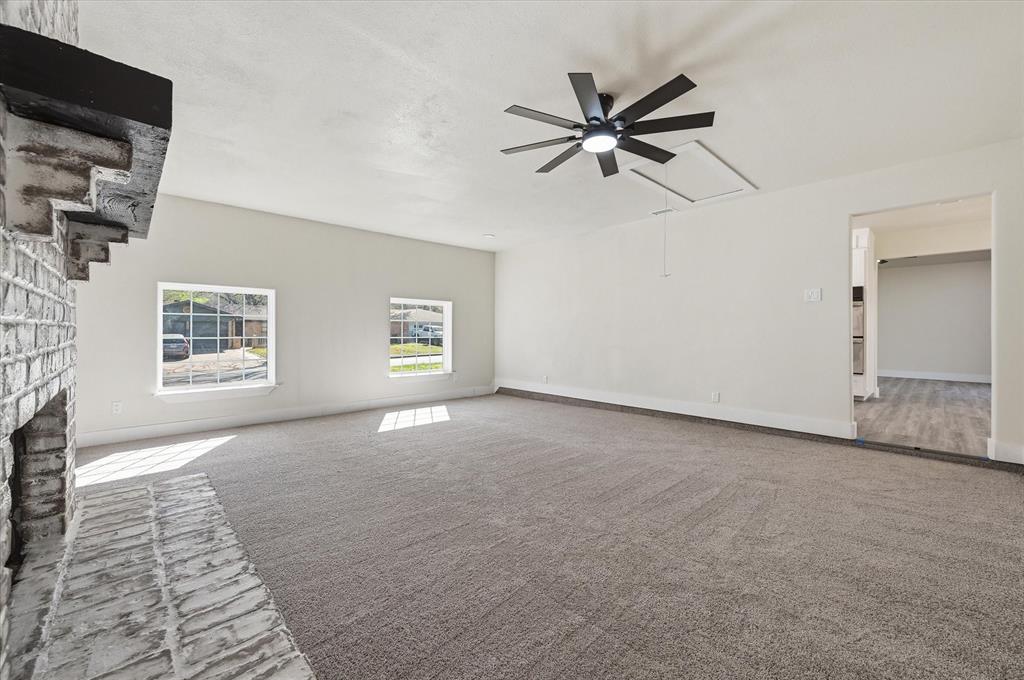 2804 Bent Tree Lane Arlington, TX 76016 - Photo 8 of 32 an empty room with windows and fan