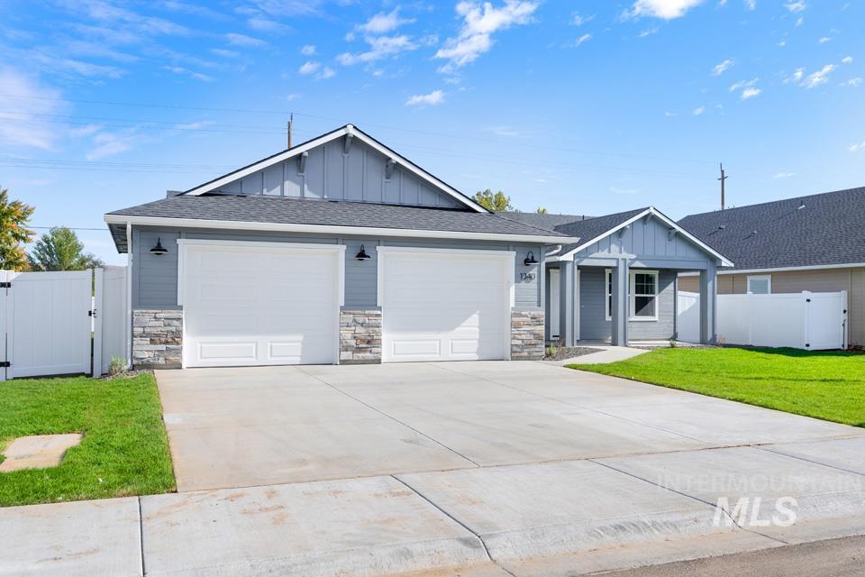 1340 Dawn Street Weiser, ID 83672 - Photo 2 of 32 Craftsman-style house featuring board and batten siding, a gate, driveway, and roof with shingles