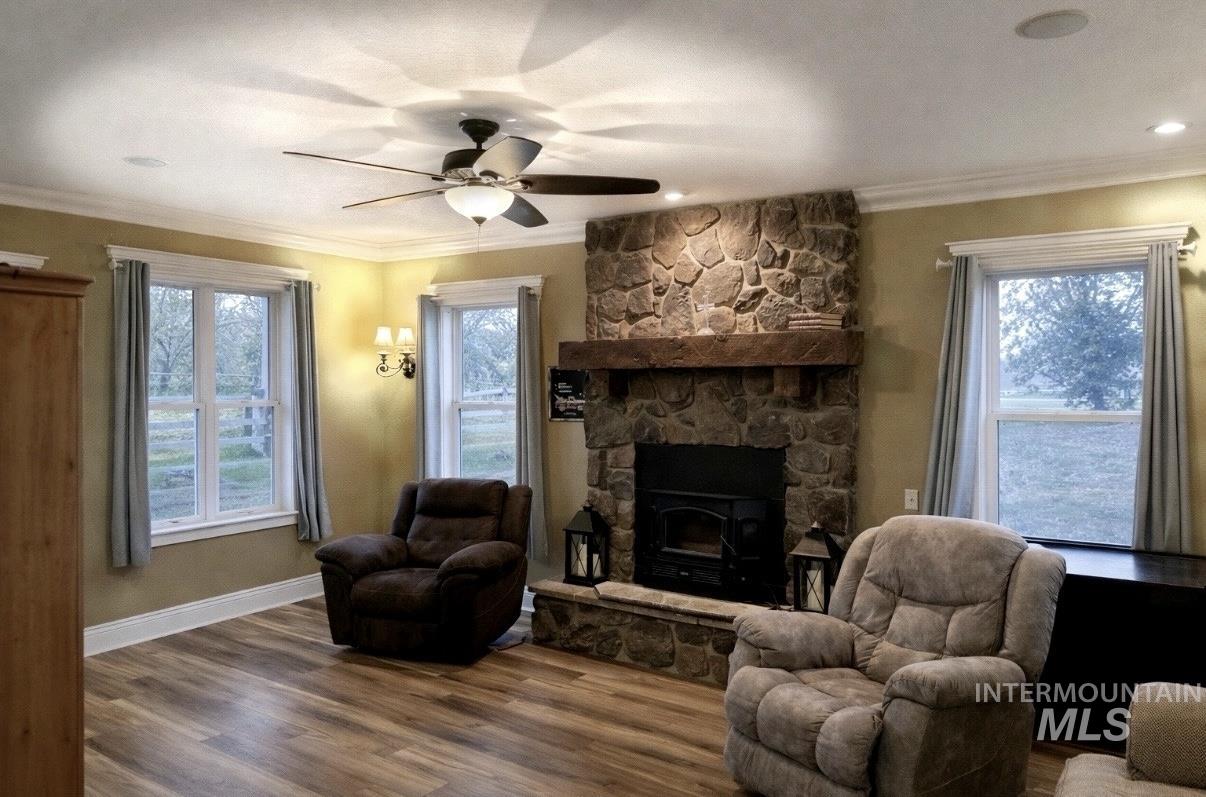 20169 Hoskins Road Caldwell, ID 83607 - Photo 27 of 46 Living room featuring ornamental molding, wood finished floors, and a ceiling fan