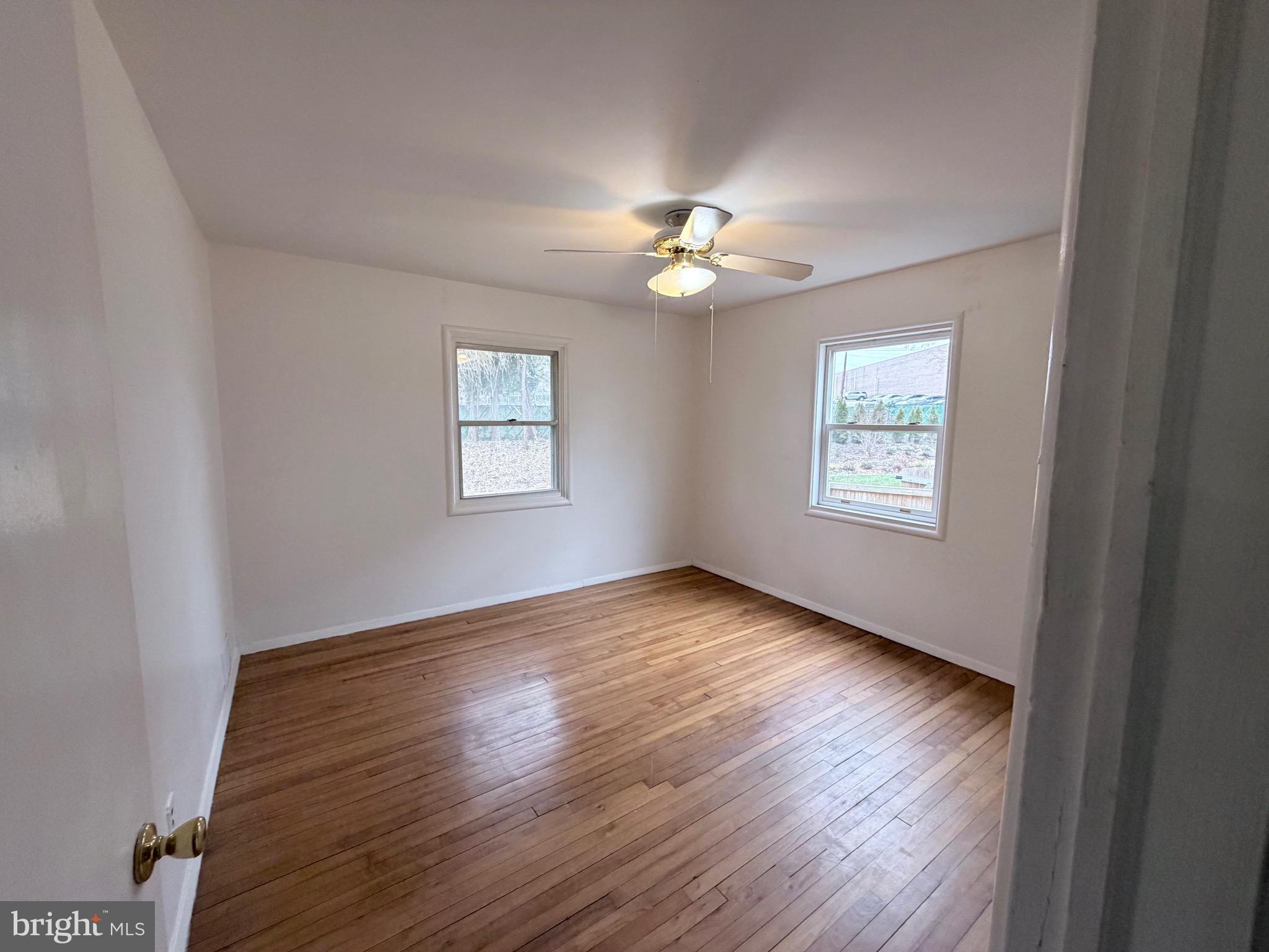 2207 Luzerne Avenue Silver Spring, MD 20910 - Photo 14 of 39 a view of an empty room with a window and wooden floor