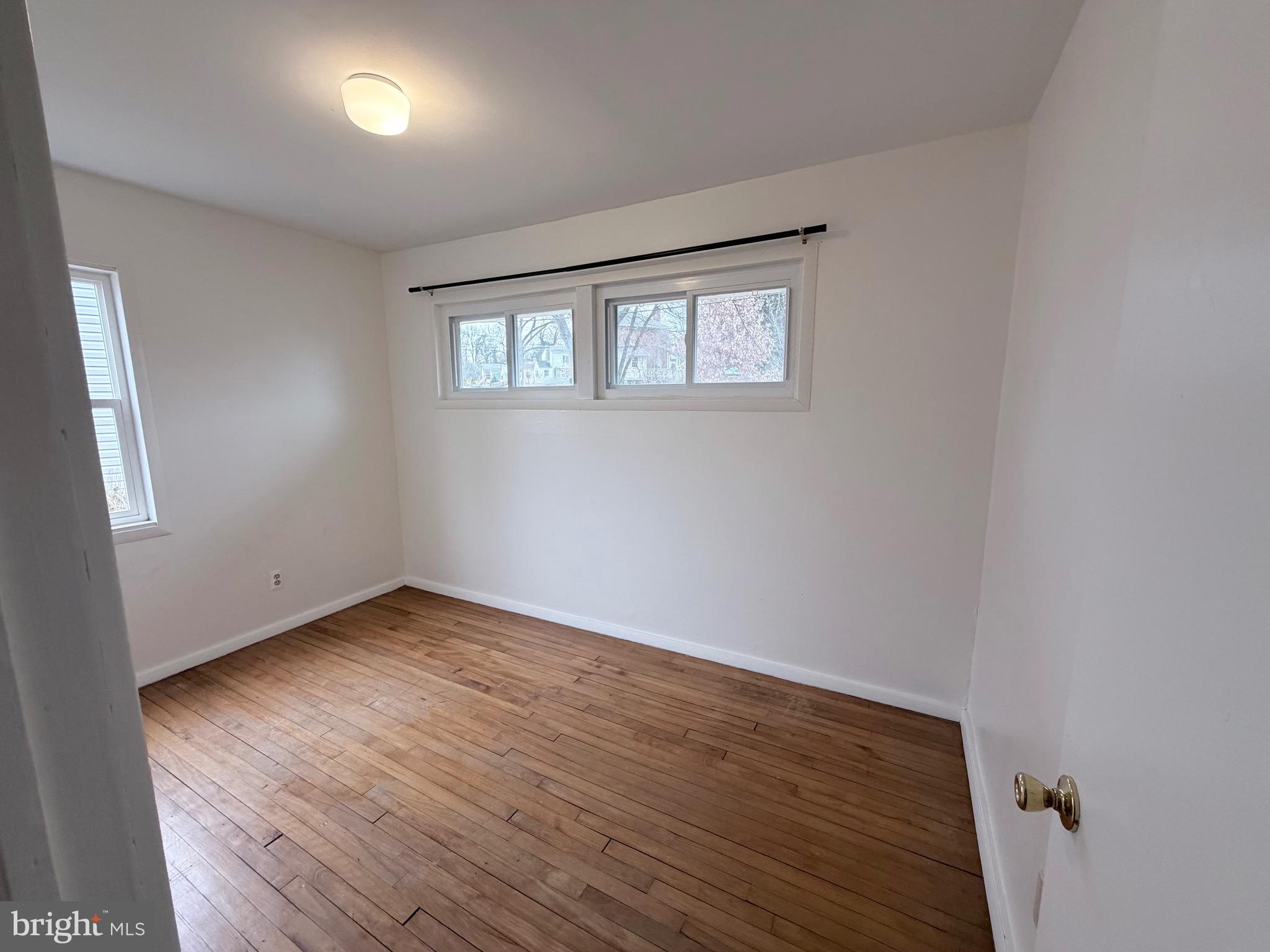 2207 Luzerne Avenue Silver Spring, MD 20910 - Photo 15 of 39 an empty room with wooden floor and windows