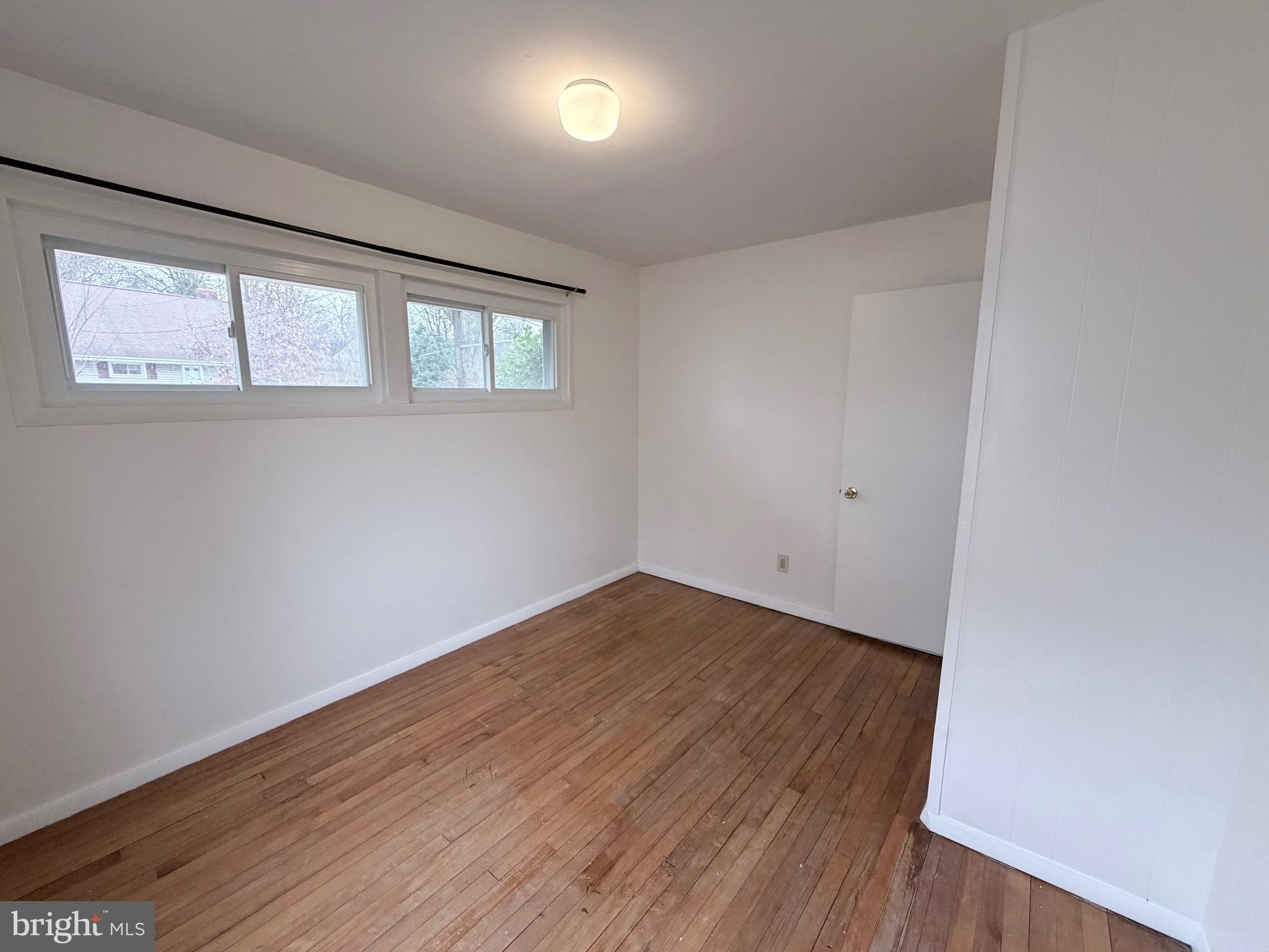 2207 Luzerne Avenue Silver Spring, MD 20910 - Photo 16 of 39 an empty room with wooden floor and windows