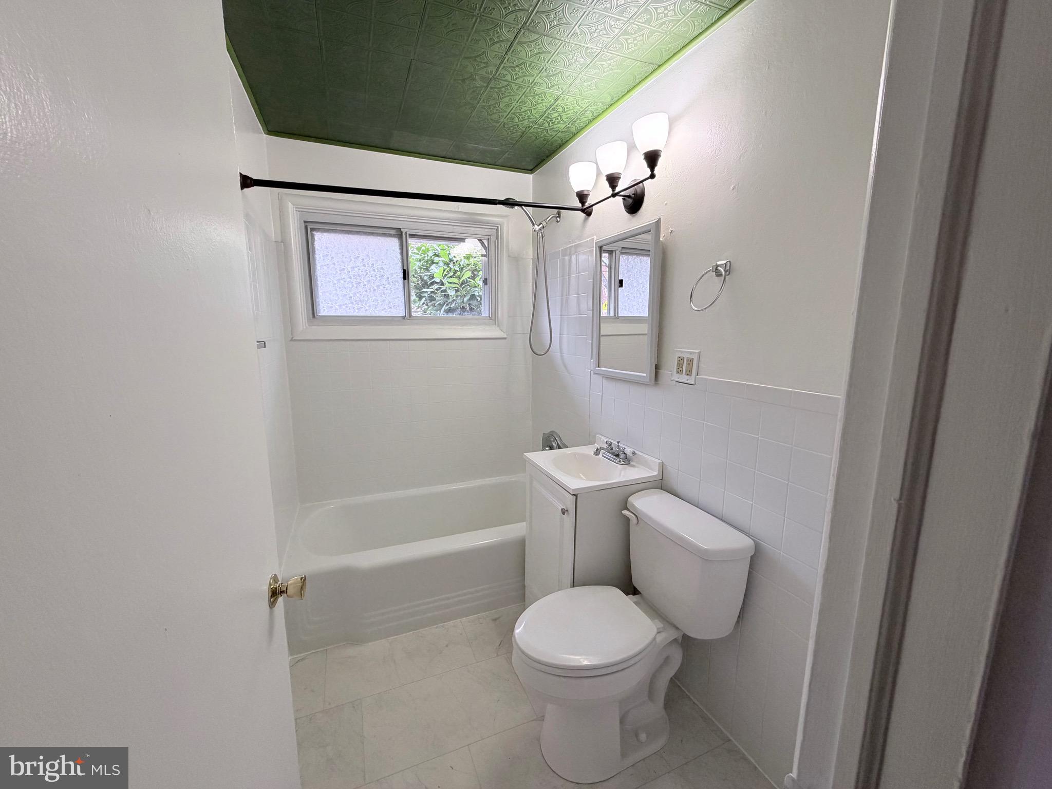 2207 Luzerne Avenue Silver Spring, MD 20910 - Photo 18 of 39 a white toilet sitting next to a bathroom sink and tub