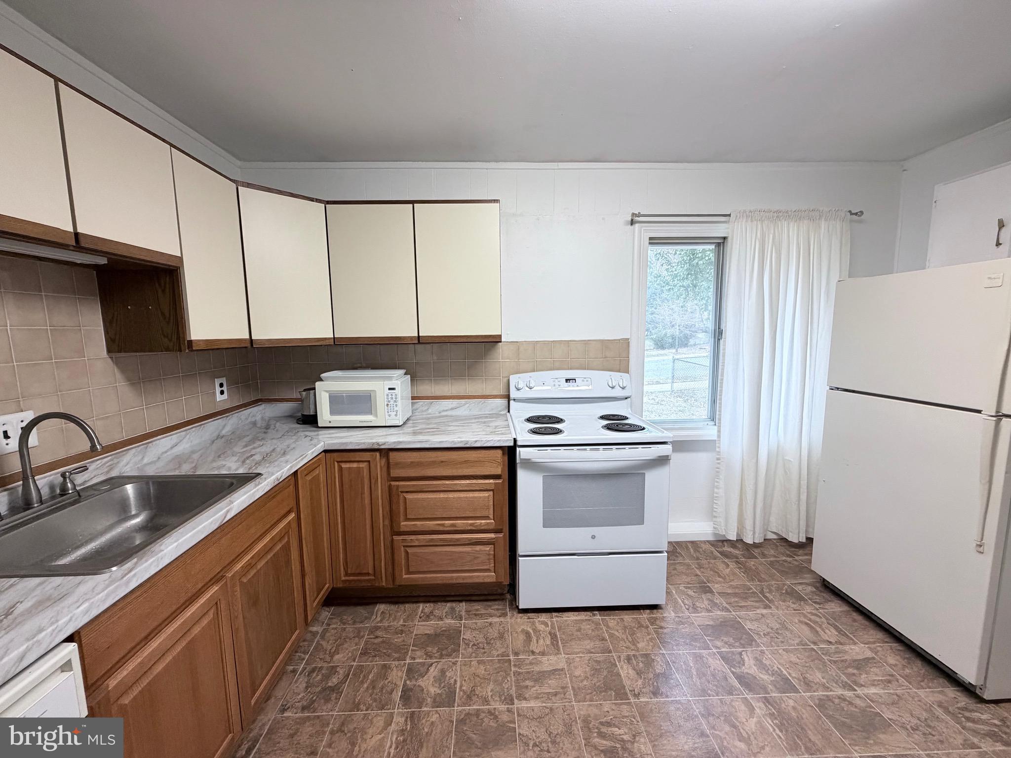 2207 Luzerne Avenue Silver Spring, MD 20910 - Photo 10 of 39 a kitchen with a sink stove and refrigerator