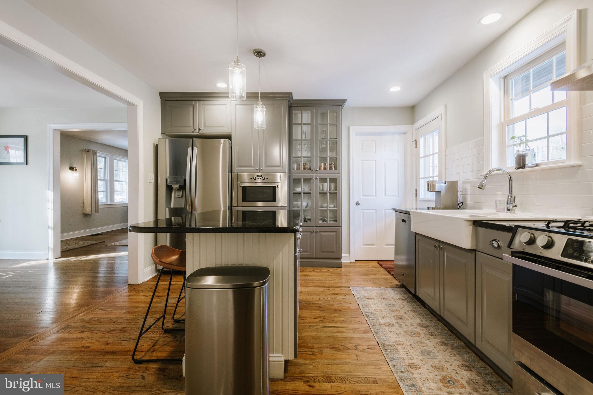 25 North Rolling Road Springfield, PA 19064 - Photo 14 of 45 a kitchen with stainless steel appliances granite countertop a refrigerator a stove and a sink