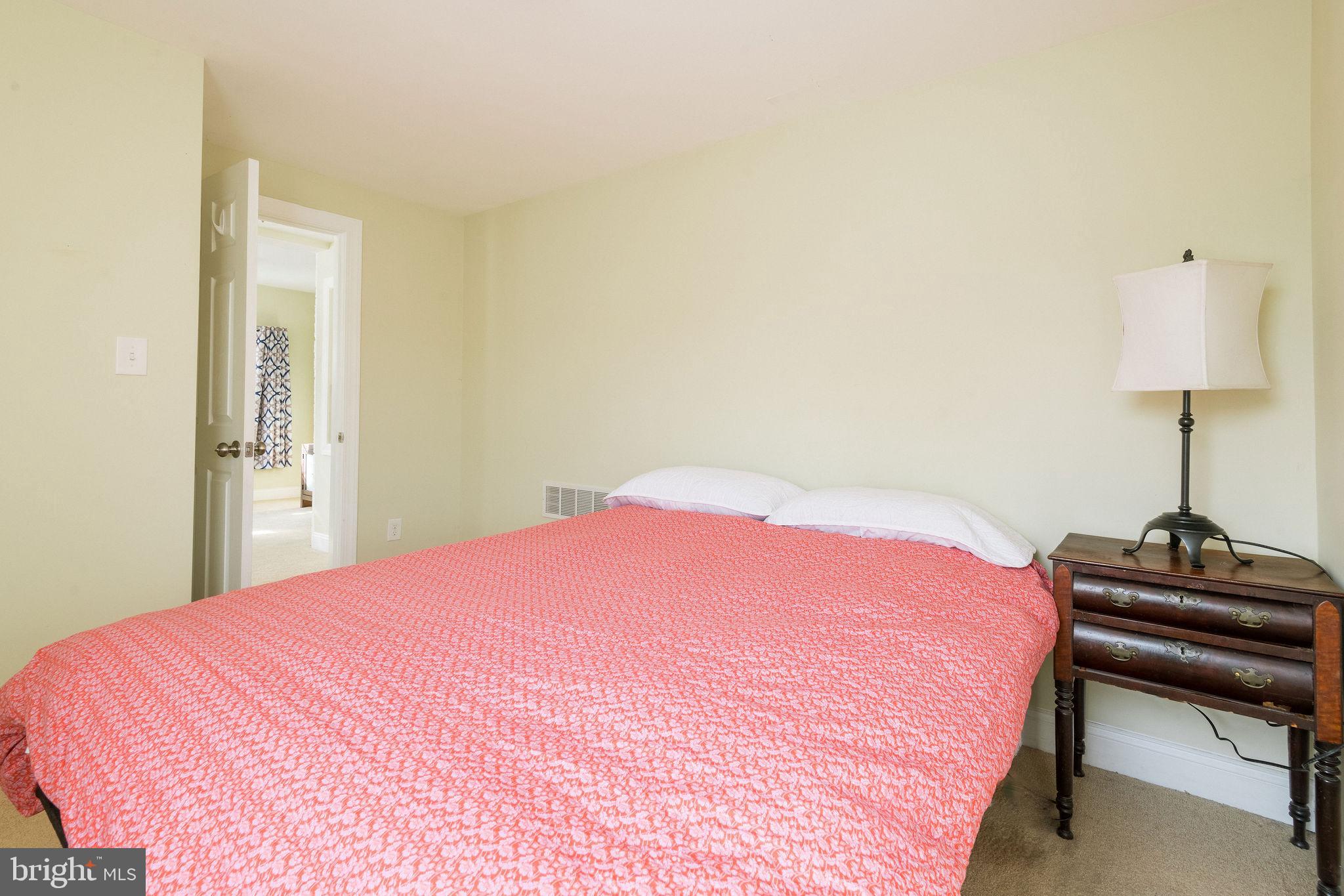 25 North Rolling Road Springfield, PA 19064 - Photo 25 of 45 a bedroom with a bed and a lamp