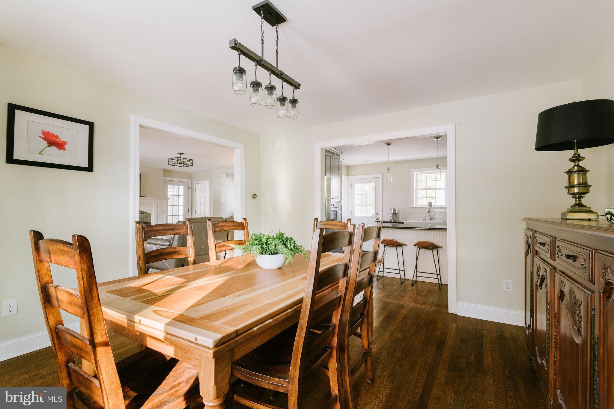 25 North Rolling Road Springfield, PA 19064 - Photo 10 of 45 a dining room with furniture a chandelier and wooden floor
