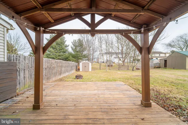 a backyard of house with a slide and large trees