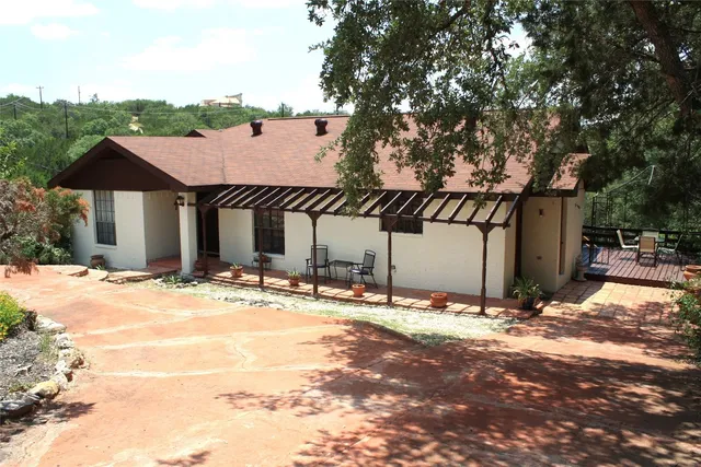 a view of a house with snow on the road