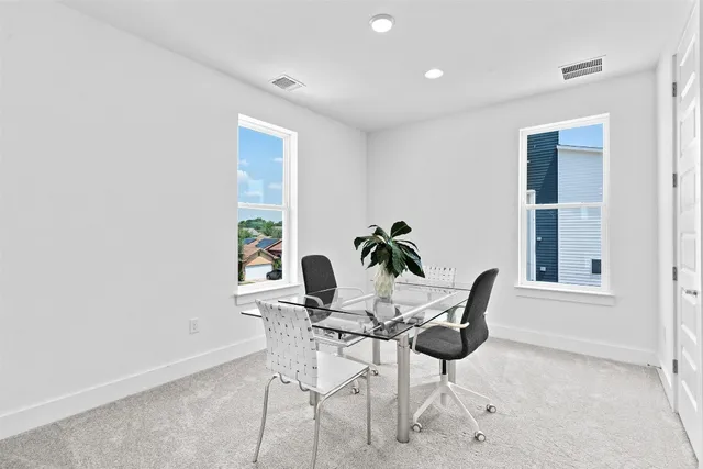 a dining room with furniture a rug and wooden floor