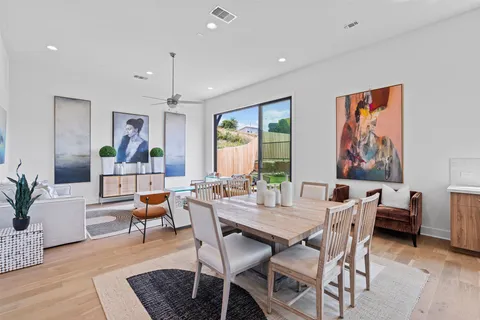 a living room with wooden floor and furniture