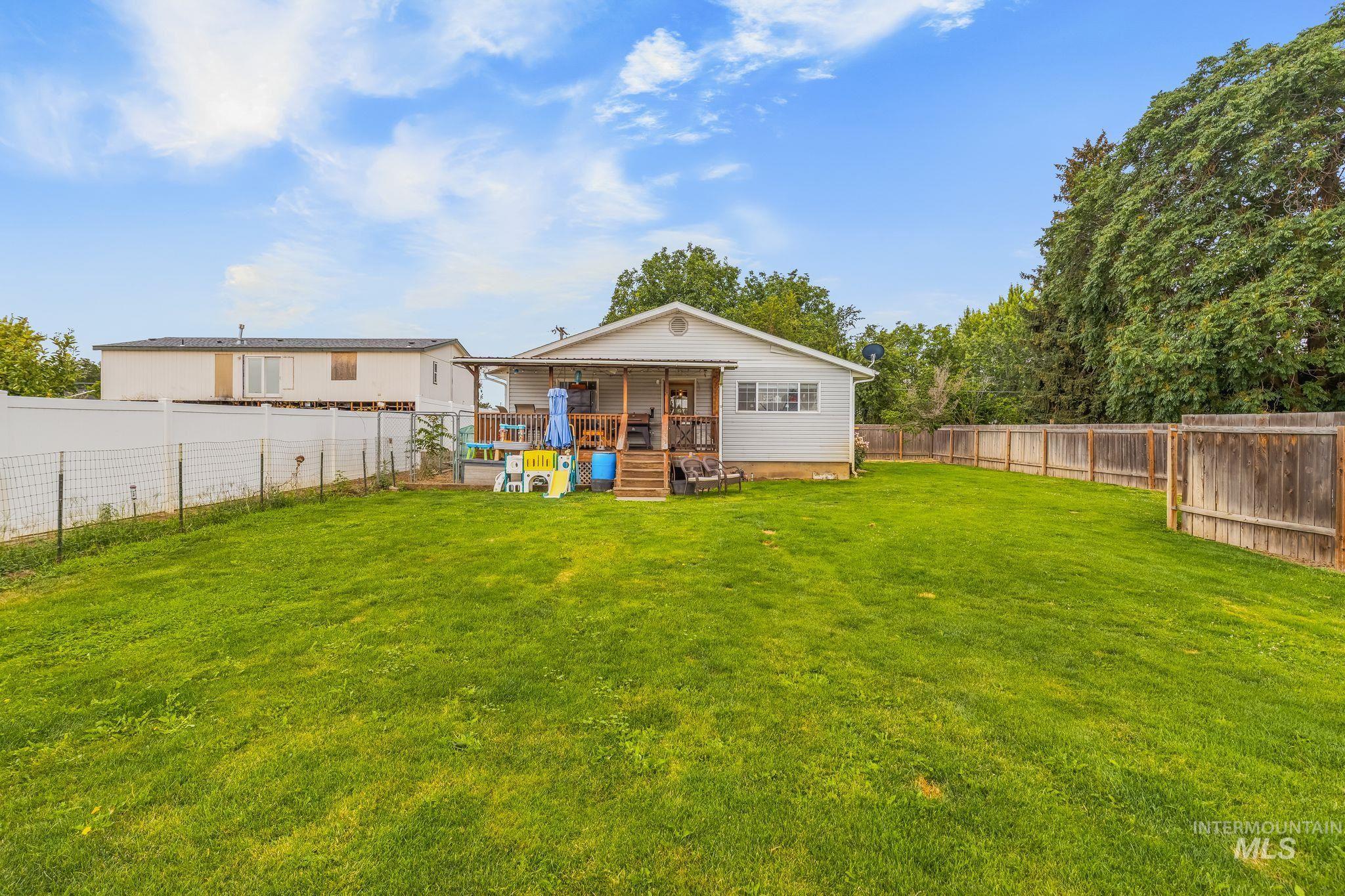 2119 Ripon Avenue Lewiston, ID 83501 - Photo 36 of 50 Expansive green lawn with a white vinyl fence and a wood privacy fence