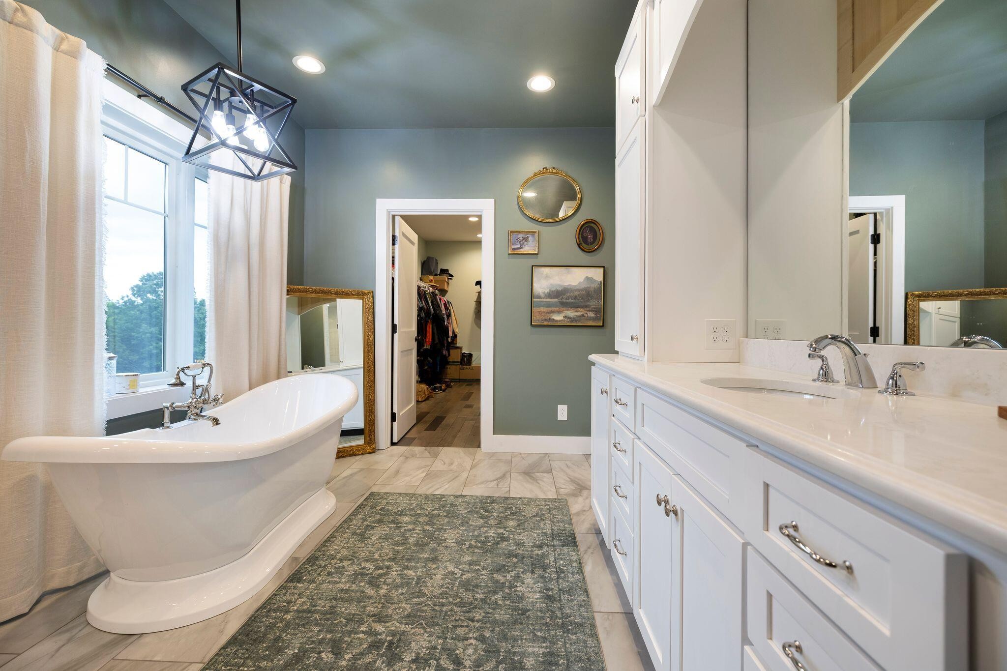 6866 Daus Mountain Road Whitwell, TN 37397 - Photo 24 of 49 a spacious bathroom with a double vanity sink a mirror and a bathtub
