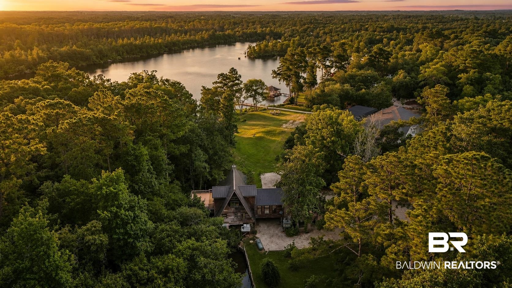 14587 Ridge Road Summerdale, AL 36580 - Photo 42 of 44 Aerial view of a secluded property featuring a prominent A-frame structure and a secondary building, surrounded by extensive mature trees