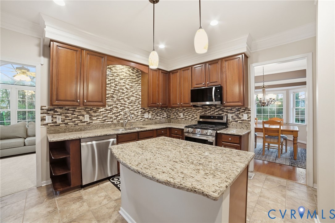 11801 Alder Ridge Place Glen Allen, VA 23059 - Photo 11 of 31 a kitchen with stainless steel appliances granite countertop a stove top oven a sink dishwasher a dining table and chairs with wooden floor