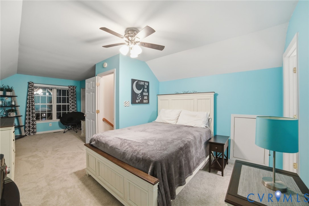 11801 Alder Ridge Place Glen Allen, VA 23059 - Photo 15 of 31 a bedroom with a bed and a chandelier