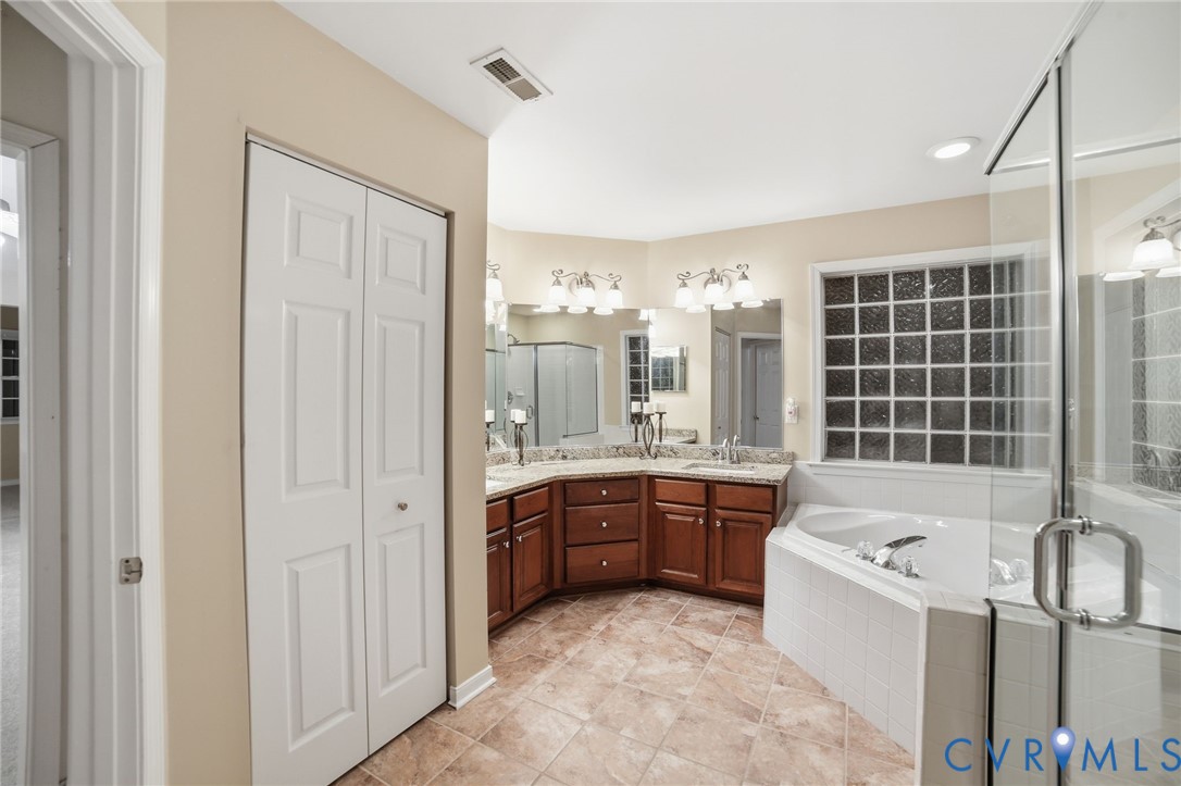 11801 Alder Ridge Place Glen Allen, VA 23059 - Photo 17 of 31 a large bathroom with a tub sink and mirror