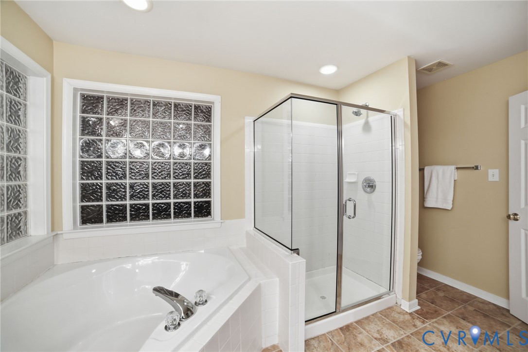 11801 Alder Ridge Place Glen Allen, VA 23059 - Photo 18 of 31 a bathroom with a bathtub and a shower