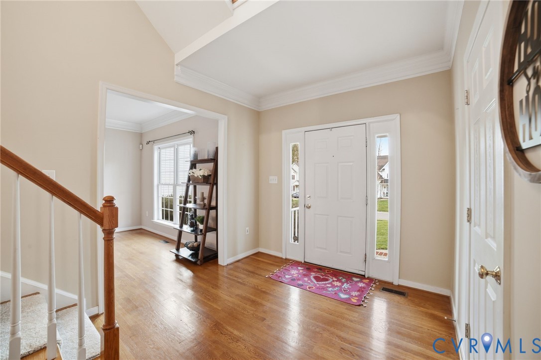 11801 Alder Ridge Place Glen Allen, VA 23059 - Photo 4 of 31 a view of an empty room with wooden floor and stairs