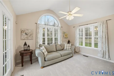 a living room with furniture and a large window