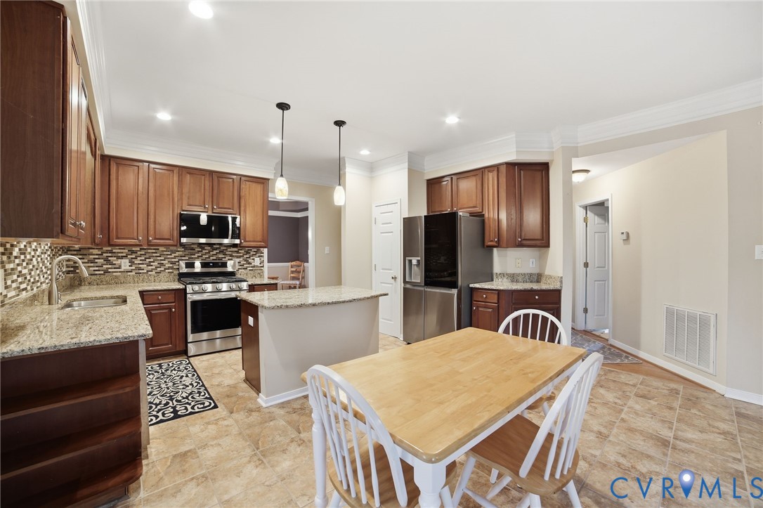 11801 Alder Ridge Place Glen Allen, VA 23059 - Photo 10 of 31 a kitchen with stainless steel appliances granite countertop a stove refrigerator sink and cabinets