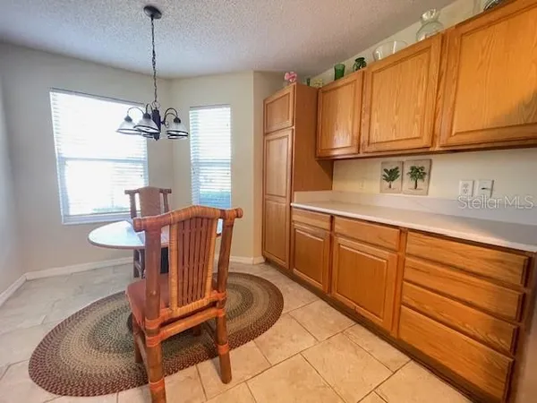 a kitchen with stainless steel appliances granite countertop a sink a stove cabinets and dining table with wooden floor