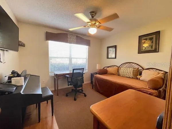 a view of a workspace with furniture and a window